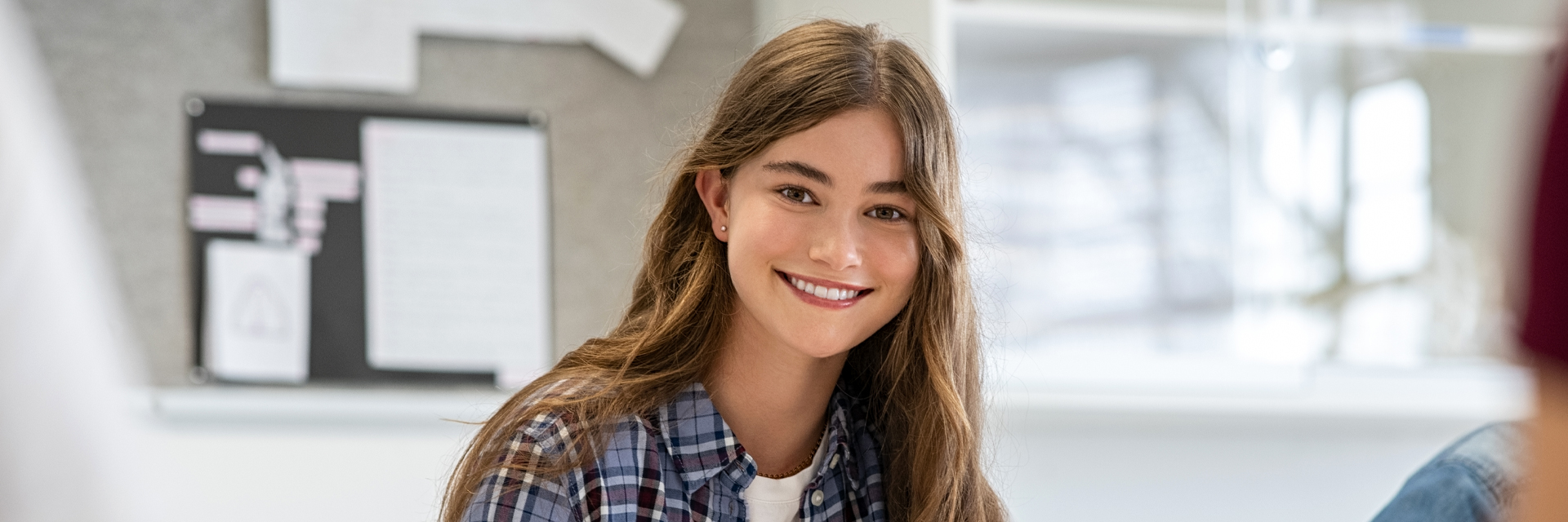 Smiling girl happy to know about bone grafting and dental implants in Whitby, ON.