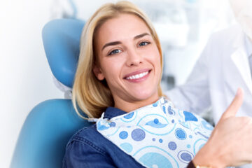 Girl happy and showing thumb up for her root canal treatment in Whitby, ON.