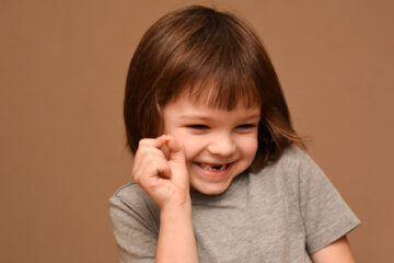 Girl holding a broken baby teeth in Whitby, ON