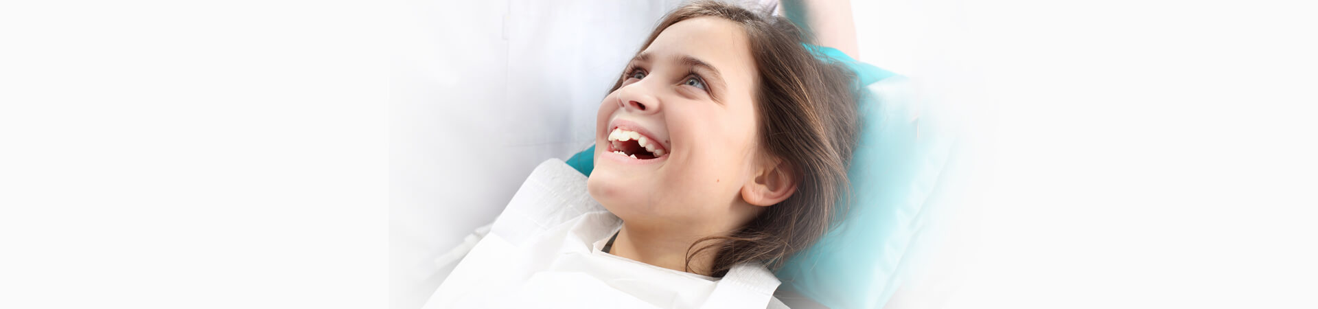 Little smiling girl ready for treatment by kids dentist in Whitby, ON.