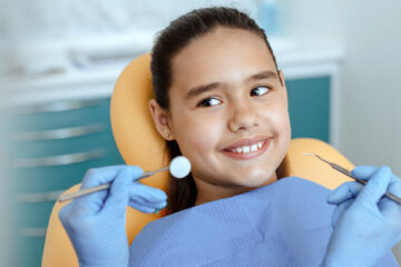 Smiling baby girl happily visiting the kids dentist in Whitby, ON.