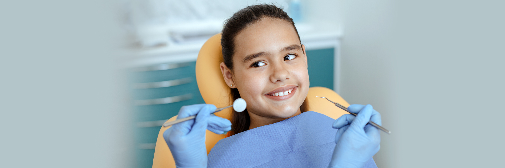 Smiling baby girl happily visiting the kids dentist in Whitby, ON.