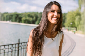 Lady with perfect white teeth after professional teeth whitening at Brooklin Village Dental Care.