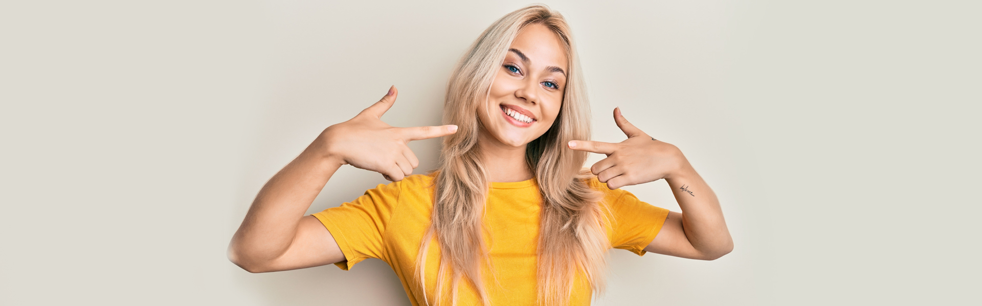 Smiling girl with perfect teeth after getting dental crowns in Whitby, ON.