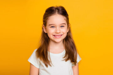 Smiling kid with healthy teeth after regular dental chekups at Whitby dental clinic.
