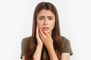Girl having severe toothache.