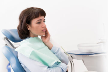 Lady in severe teeth pain visiting a nearby Whitby dental clinic.